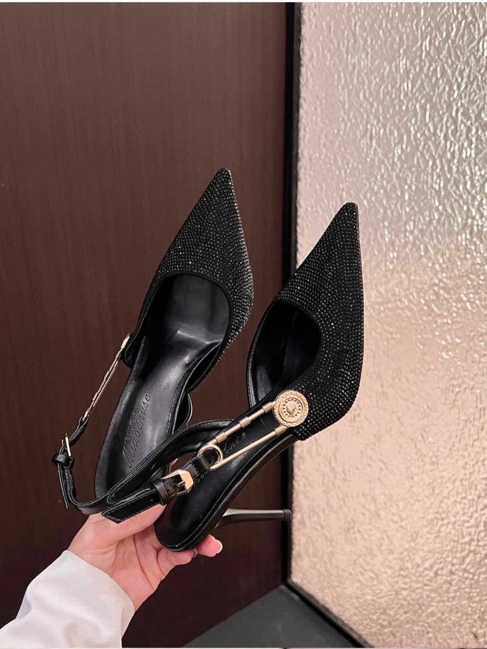 A Classy ChicBlack Rhinestone Pointed Slingback Pumps with Gold Accent.